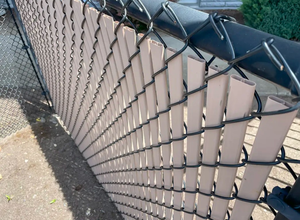 Chain-link fence with privacy slats